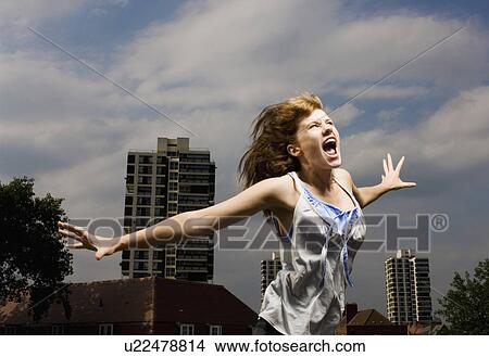 Picture - Woman screaming in city. Fotosearch