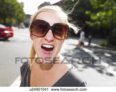 Stock Image - Woman screaming in the street. Fotosearch