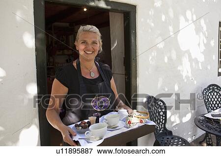 Woman serving tea and chocolate View Large Photo Image Stock Photo - Woman serving tea and chocolate. Fotosearch