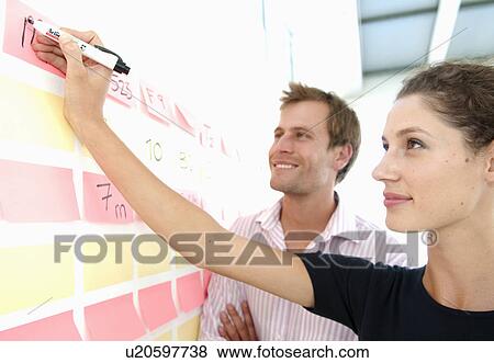 Woman shares data with colleague View Large Photo Image Stock Photo - Woman shares data with colleague. Fotosearch
