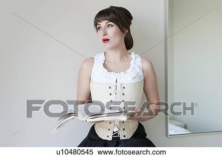 Woman singing from music book View Large Photo Image Stock Photography - Woman singing from music book. Fotosearch