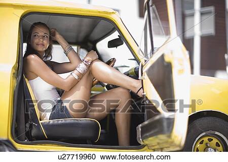 Stock Image - Woman sitting in a car. Fotosearch
