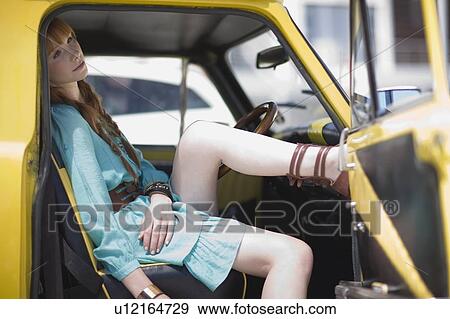 Stock Photo - Woman sitting in a car. Fotosearch