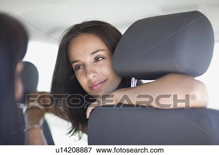 Woman sitting in a car View Large Photo Image Stock Photo - Woman sitting in a car. Fotosearch