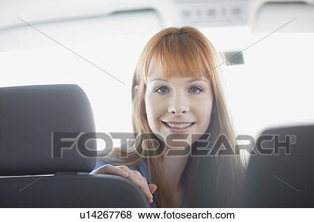 Stock Photo - Woman sitting in a car. Fotosearch