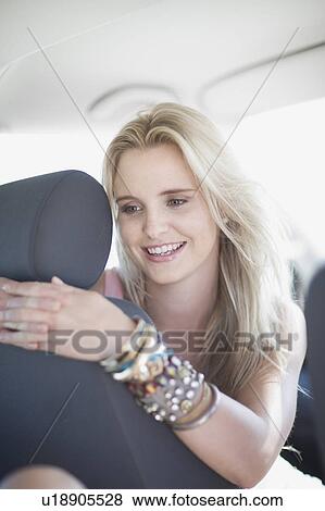 Stock Photo - Woman sitting in a car. Fotosearch