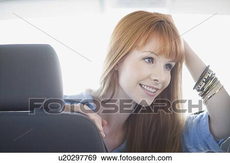 Stock Photo - Woman sitting in a car. Fotosearch
