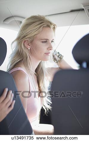 Stock Photography - Woman sitting in a car. Fotosearch