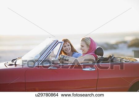 Woman sitting in a convertible car View Large Photo Image Picture - Woman sitting in a convertible car. Fotosearch