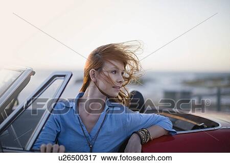 Stock Photo - Woman sitting in her car. Fotosearch