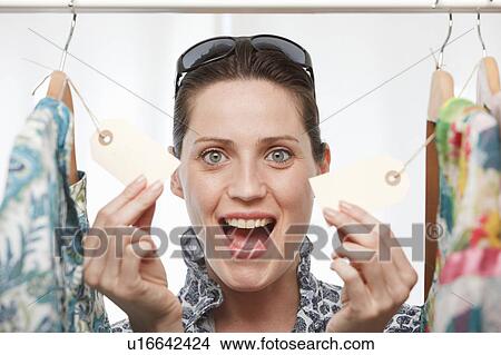 woman smiling holding price tags View Large Photo Image Picture - woman smiling holding price tags. Fotosearch