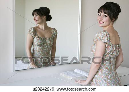 Woman smiling in front of mirror View Large Photo Image Stock Photo - Woman smiling in front of mirror. Fotosearch