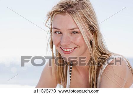 Woman smiling on beach View Large Photo Image Stock Image - Woman smiling on beach. Fotosearch