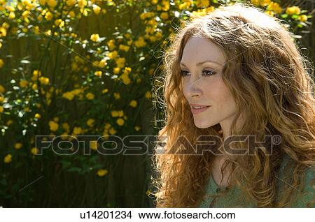 Picture - Woman smiling outdoors. Fotosearch