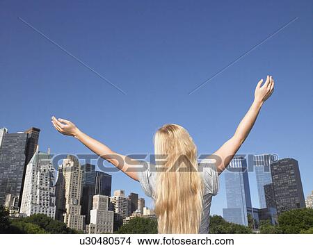 Woman spreading her arms in central park View Large Photo Image Picture - Woman spreading her arms in central park. Fotosearch