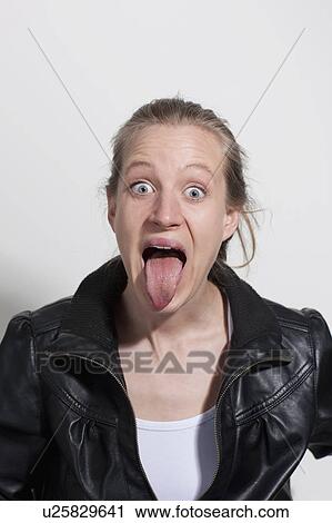 Stock Image - Woman sticks tongue out. Fotosearch