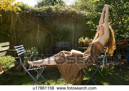 Woman stretching in backyard View Large Photo Image Stock Photo - Woman stretching in backyard. Fotosearch