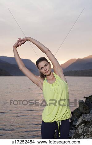 woman stretching in front of lake View Large Photo Image Picture - woman stretching in front of lake . Fotosearch