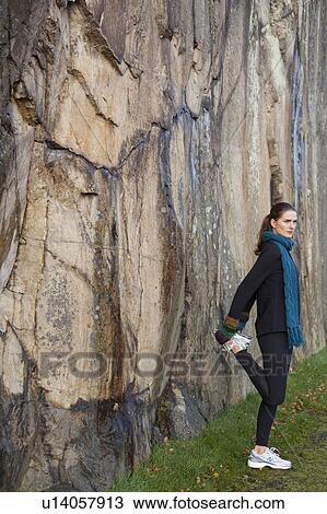 woman stretching in front of rockface View Large Photo Image Stock Image - woman stretching in front of rockface. Fotosearch