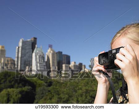 Woman taking pictures in central park View Large Photo Image Stock Image - Woman taking pictures in central park. Fotosearch