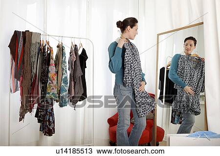 woman trying on clothes View Large Photo Image Stock Image - woman trying on clothes. Fotosearch