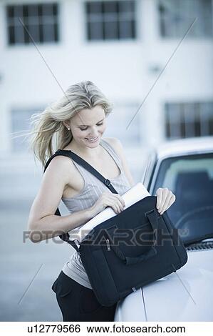 Stock Photograph - Woman unpacking her notebook. Fotosearch