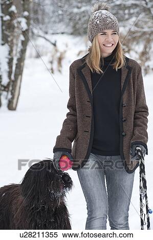 Woman walking dog in snow View Large Photo Image Stock Photography - Woman walking dog in snow. Fotosearch