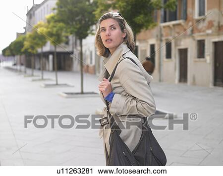 Woman walking in the street View Large Photo Image Stock Image - Woman walking in the street. Fotosearch
