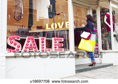 Stock Photo - woman walking into a shop. Fotosearch