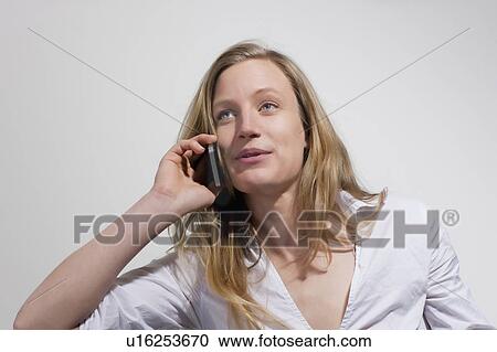 Stock Image - Woman with cellphone smiling. Fotosearch