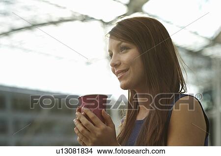 Woman with coffecup smiling View Large Photo Image Picture - Woman with coffecup smiling. Fotosearch