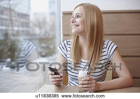 Woman with coffee and cellphone View Large Photo Image Stock Photography - Woman with coffee and cellphone. Fotosearch