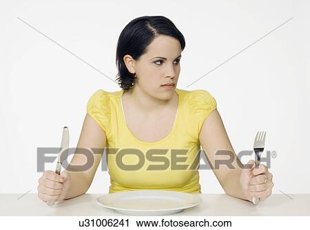 Stock Image - woman with empty plate. Fotosearch
