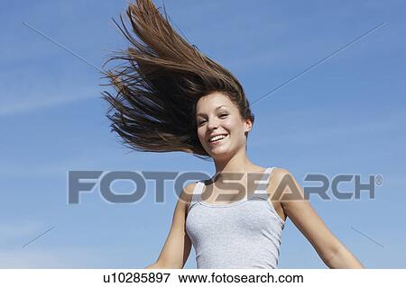 Woman with flying hair smiling View Large Photo Image Stock Photo - Woman with flying hair smiling. Fotosearch