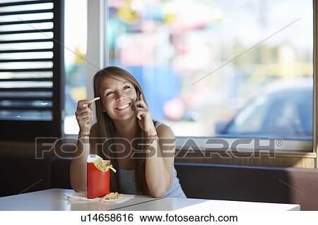 Woman with Frenchfries and Cellphone View Large Photo Image Stock Photograph - Woman with Frenchfries and Cellphone. Fotosearch