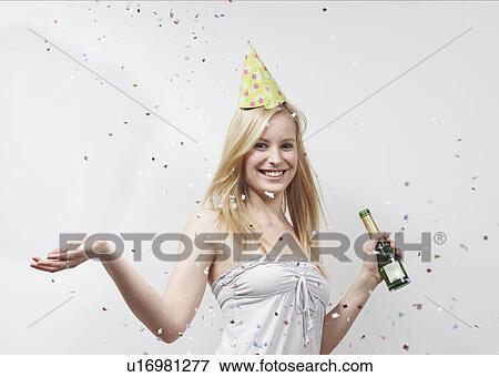 Stock Photo - Woman with funny hat and confetti. Fotosearch