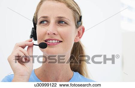 Woman with headset in bright office View Large Photo Image Stock Image - Woman with headset in bright office. Fotosearch