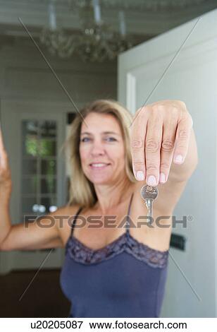 Woman with house keys View Large Photo Image Stock Photo - Woman with house keys. Fotosearch