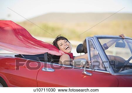 Woman with long red scarf riding in car View Large Photo Image Stock Image - Woman with long red scarf riding in car. Fotosearch