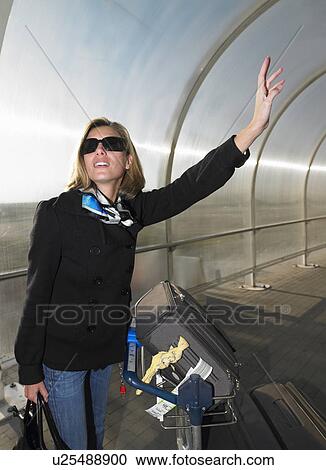 Woman with luggages calling for a cab View Large Photo Image Stock Image - Woman with luggages calling for a cab. Fotosearch
