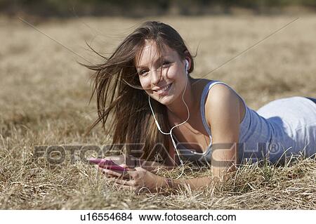 Woman with mp3 player smiling View Large Photo Image Picture - Woman with mp3 player smiling. Fotosearch