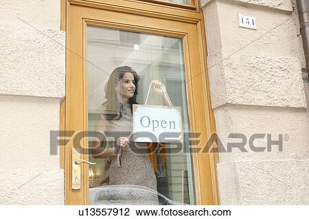 Woman with open sign View Large Photo Image Stock Image - Woman with open sign. Fotosearch
