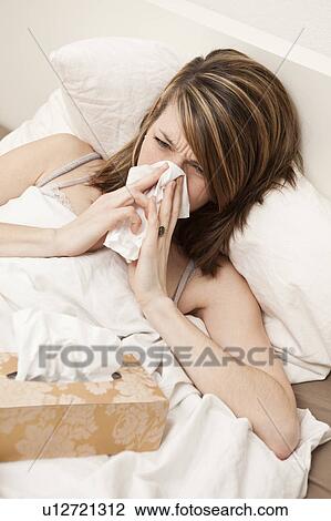 Stock Image - Woman with paper tissue. Fotosearch