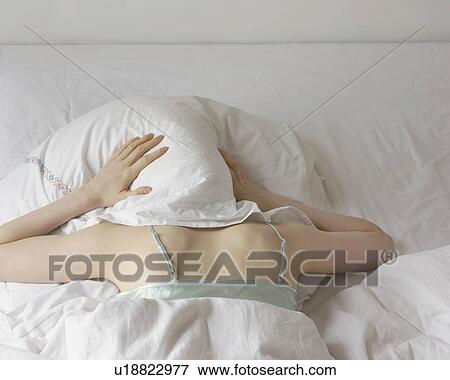 woman with pillow over head View Large Photo Image Stock Photo - woman with pillow over head. Fotosearch
