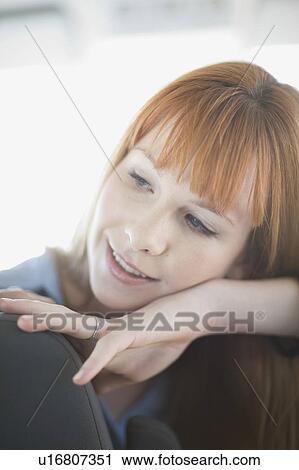 Stock Image - Woman with red hair in car. Fotosearch