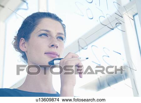 Picture - Woman writes on glass. Fotosearch