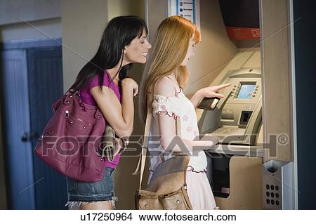 Women at a cashpoint View Large Photo Image Picture - Women at a cashpoint. Fotosearch