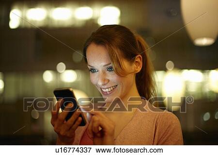 Women at night with cellphone View Large Photo Image Stock Photo - Women at night with cellphone. Fotosearch