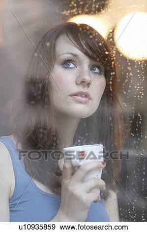 Stock Photo - Women behind Rainy Window with Cup. Fotosearch