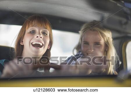 Women having fun driving a car View Large Photo Image Stock Image - Women having fun driving a car. Fotosearch